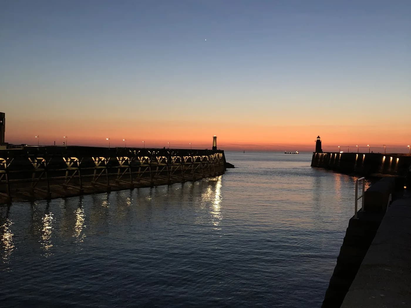 Original photo: a harbour's two jetties and its lighthouse at sunset